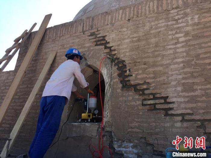 圖為“援烏茲別克斯坦花剌子模州希瓦古城歷史文化遺跡修復項目”墻體裂隙注漿工程。(資料圖) 周鵬 攝