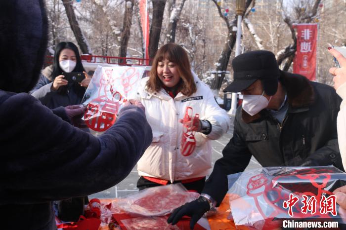 一張張寄托著美好祝愿的剪紙送給市民。　潘琦 攝